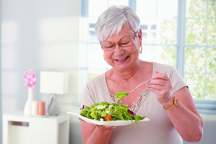 woman laughing with salad