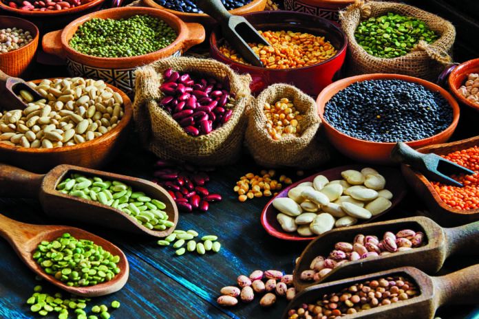 Top view of leguminous seeds on rustic wood table